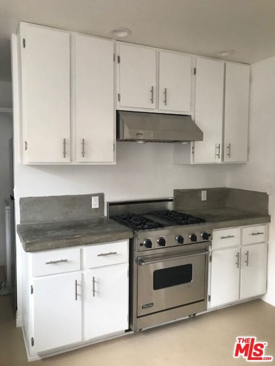 kitchen with white cabinetry and designer range