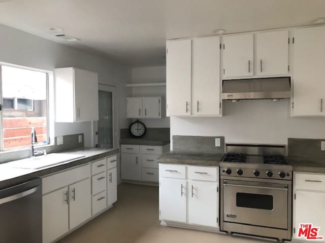 kitchen with appliances with stainless steel finishes, sink, and white cabinets