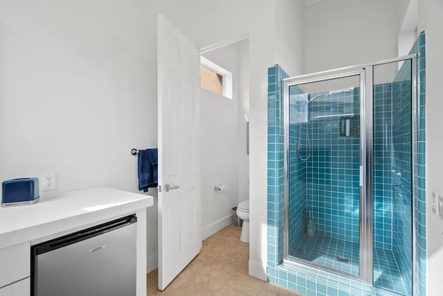 bathroom featuring tile patterned floors, toilet, and an enclosed shower