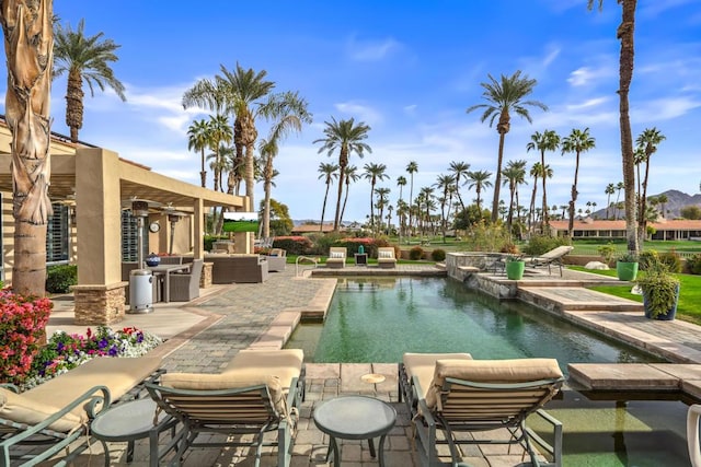 view of pool featuring an in ground hot tub, an outdoor living space, and a patio area