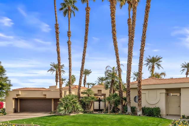 view of front of property with a garage and a front yard