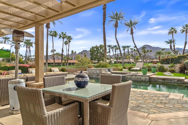 view of patio / terrace with a mountain view and a pergola