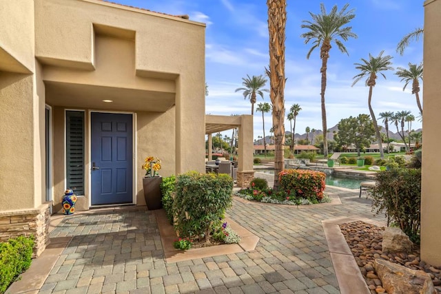 doorway to property with a patio area