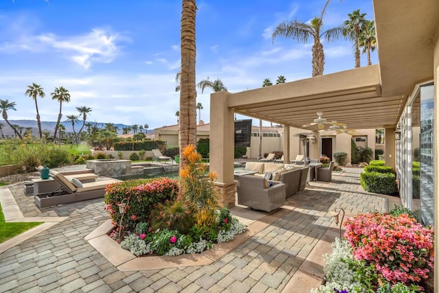 view of patio / terrace with an outdoor hangout area, ceiling fan, and a pergola