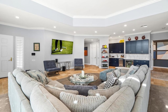 living room featuring wine cooler, ornamental molding, and bar area