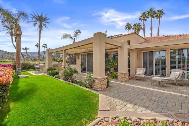 rear view of house with a patio area and a lawn