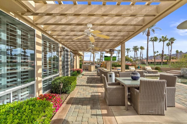 view of patio / terrace featuring a pergola, a hot tub, and ceiling fan