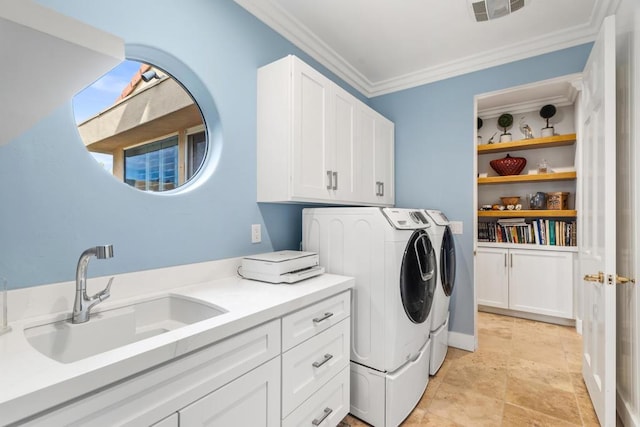 clothes washing area featuring cabinets, washing machine and dryer, sink, and crown molding