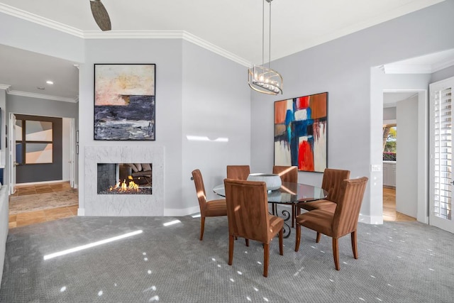 dining space featuring an inviting chandelier, ornamental molding, and carpet flooring