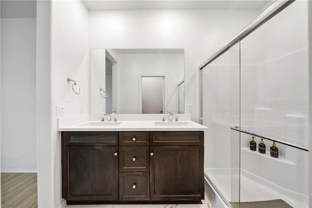 bathroom with vanity and a shower with shower door