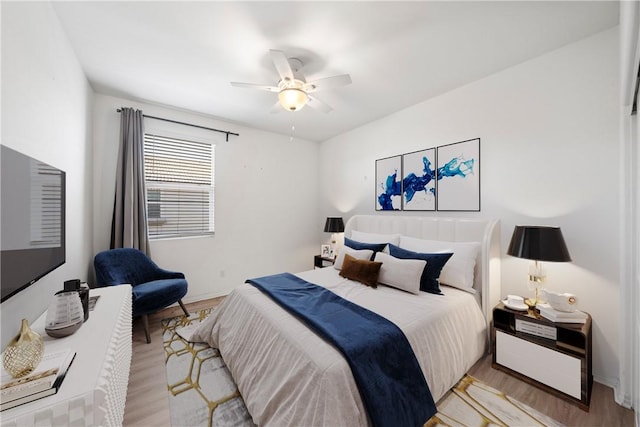 bedroom with ceiling fan and light wood-type flooring