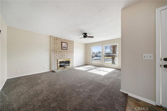 unfurnished living room featuring dark carpet, a fireplace, and ceiling fan