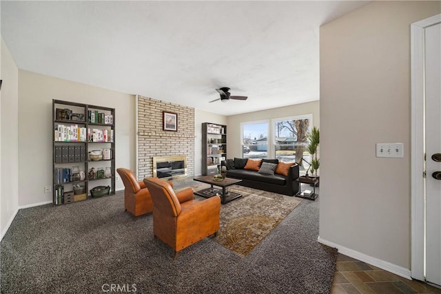 living room with a fireplace, ceiling fan, and dark colored carpet