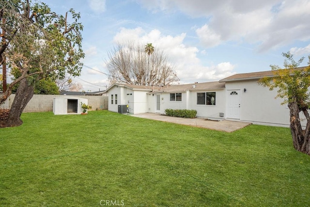 rear view of property with central AC unit, a yard, a patio area, and a shed