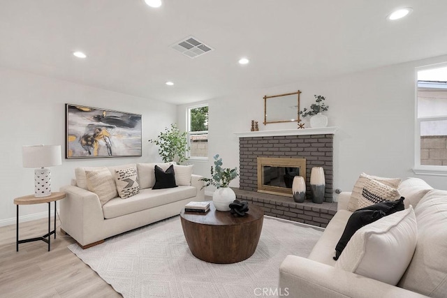 living room featuring a fireplace and light hardwood / wood-style flooring