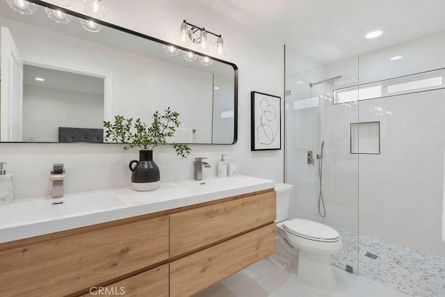 bathroom with vanity, toilet, and a shower with shower door