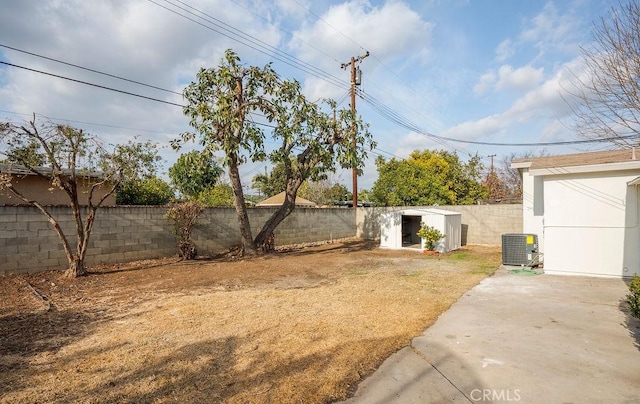 view of yard with cooling unit and a shed