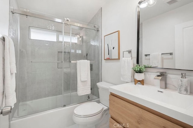 full bathroom with vanity, shower / bath combination with glass door, and toilet