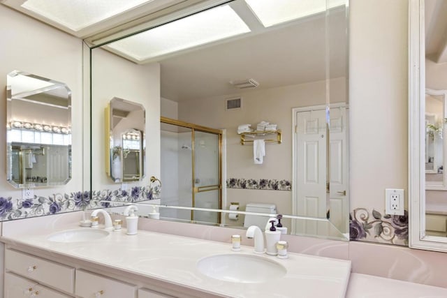 bathroom with vanity, toilet, and a shower with shower door