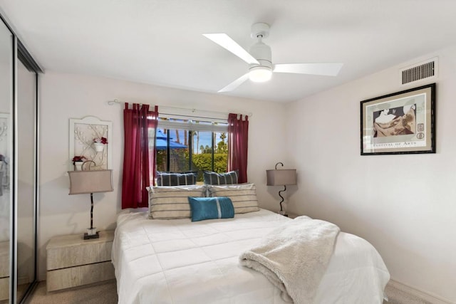 carpeted bedroom featuring a skylight, a closet, and ceiling fan