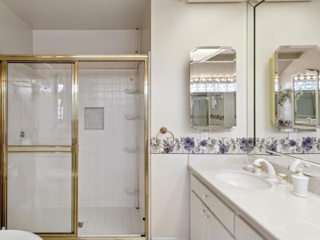 bathroom with walk in shower and vanity