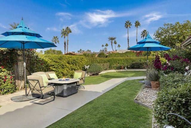 view of yard with a fire pit and a patio