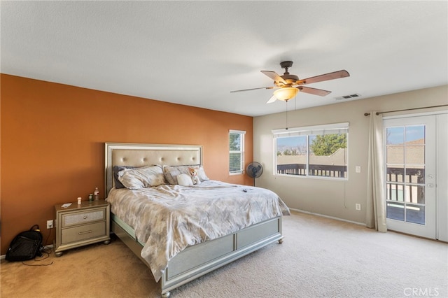 bedroom with light carpet, access to exterior, and ceiling fan