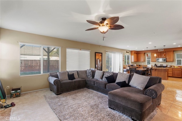 living room with plenty of natural light and ceiling fan