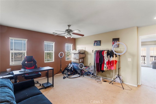 interior space featuring ceiling fan and light colored carpet