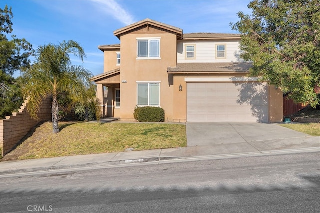 traditional-style home featuring a garage, concrete driveway, fence, a front lawn, and stucco siding