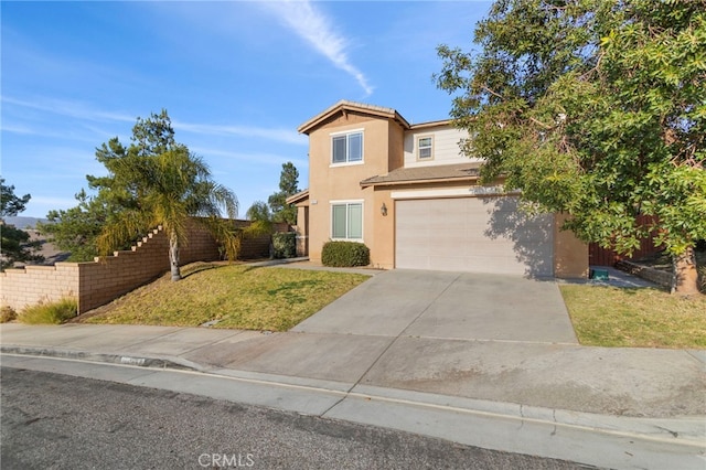 traditional-style home with stucco siding, concrete driveway, an attached garage, a front yard, and fence