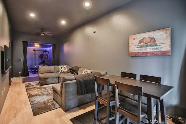 cinema featuring ceiling fan and light wood-type flooring