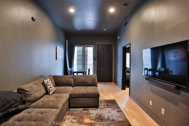 living room with light hardwood / wood-style flooring