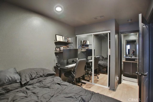 bedroom featuring light wood-type flooring and a closet