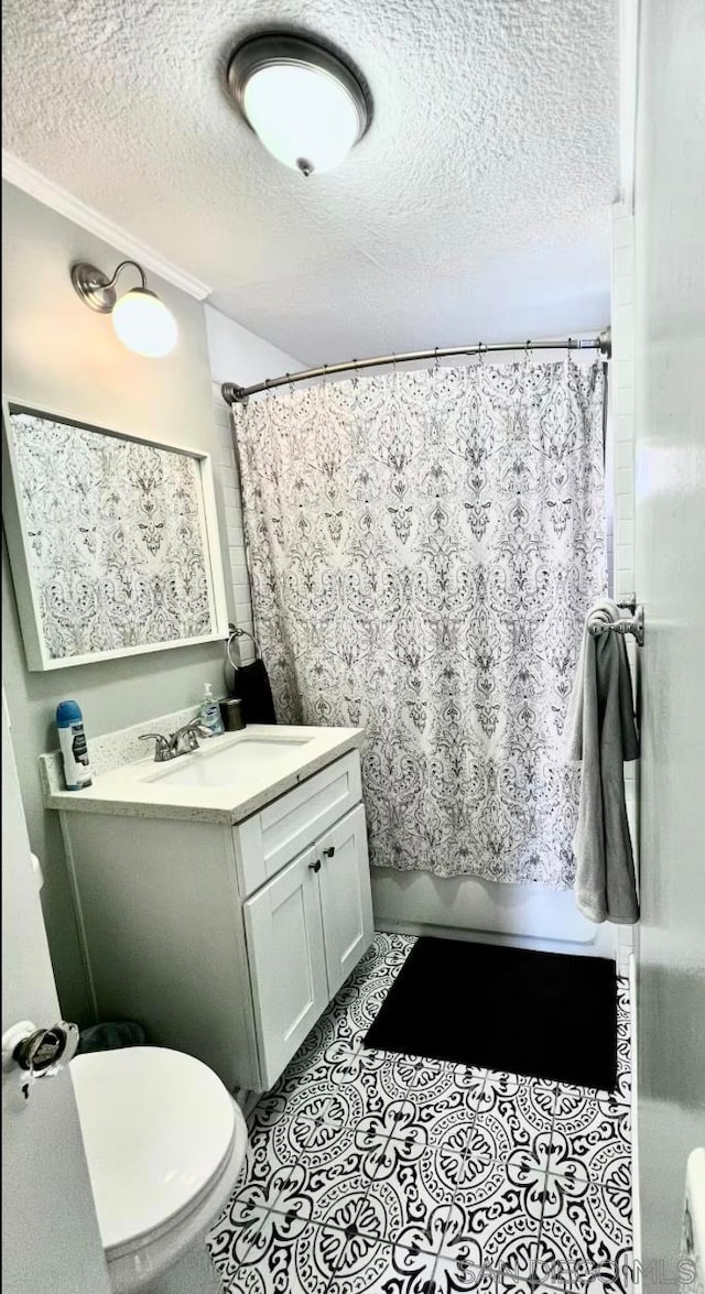 bathroom with toilet, vanity, walk in shower, crown molding, and a textured ceiling