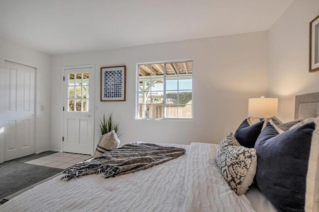 bedroom featuring multiple windows and light colored carpet