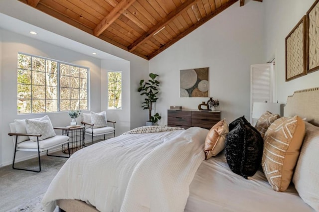 carpeted bedroom with beam ceiling, high vaulted ceiling, and wooden ceiling