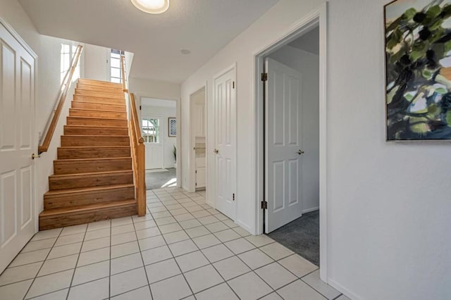 stairs with tile patterned floors