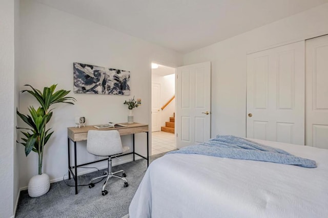 bedroom with light colored carpet and a closet