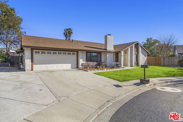 ranch-style home with a garage and a front yard