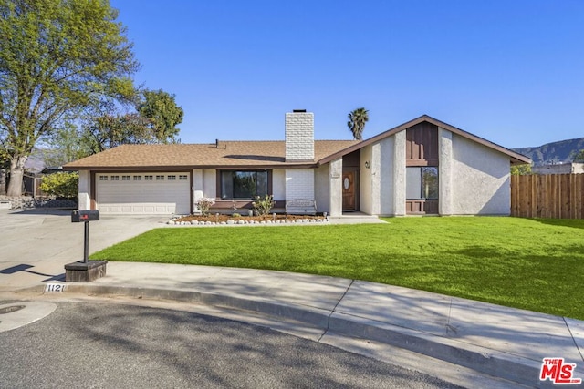 single story home with a garage and a front yard