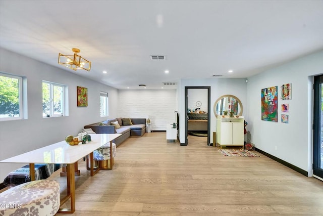 living room featuring an inviting chandelier and light hardwood / wood-style floors