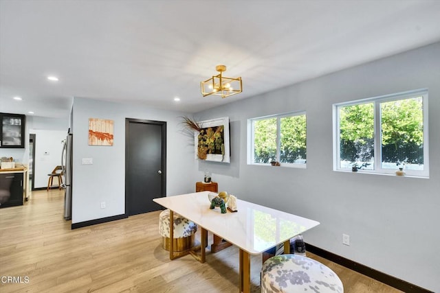 dining room with an inviting chandelier and light hardwood / wood-style flooring