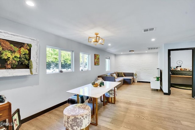 dining space featuring a chandelier and light hardwood / wood-style floors