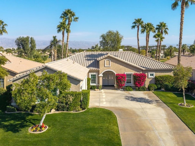 mediterranean / spanish-style house with a front yard