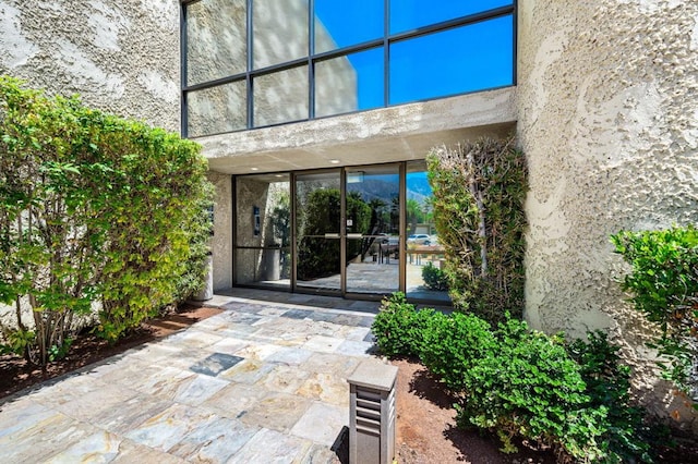 property entrance featuring a patio area