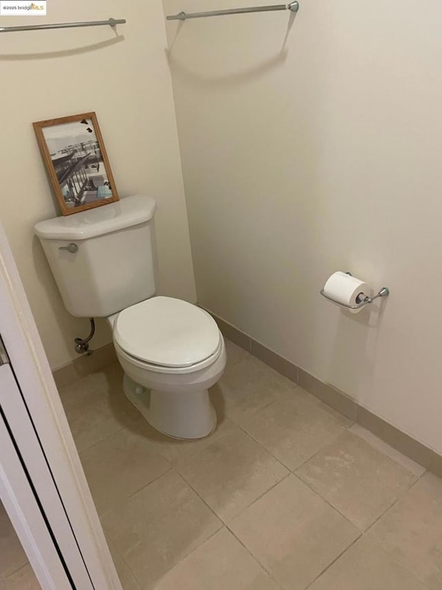 bathroom featuring toilet and tile patterned flooring