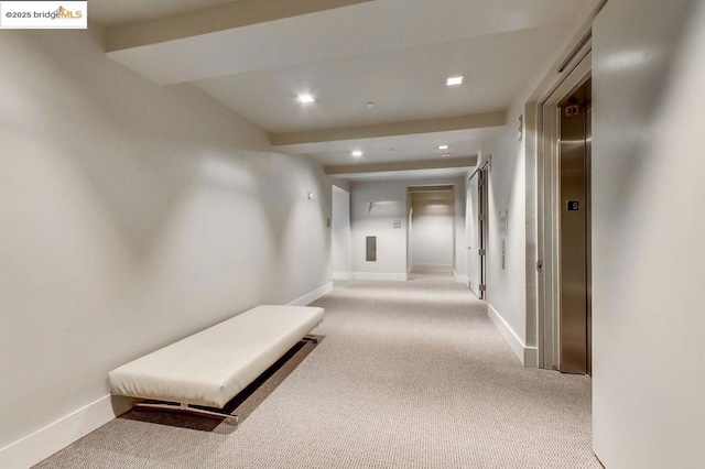 hall featuring elevator and light carpet