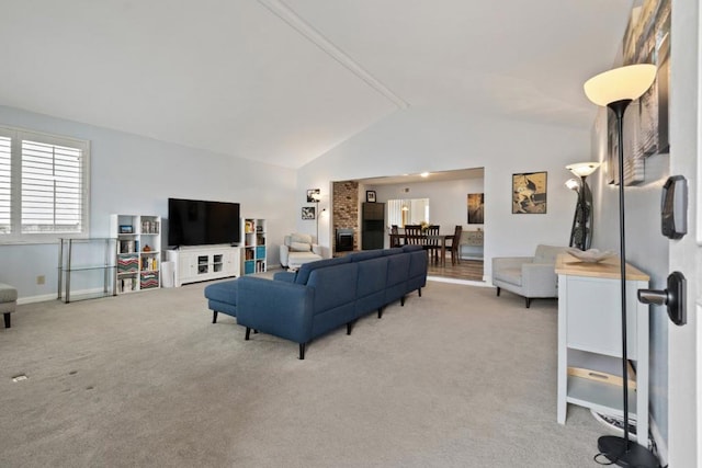 carpeted living room featuring vaulted ceiling