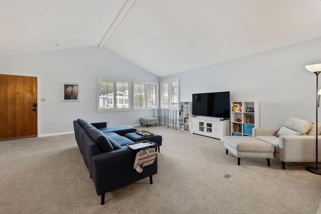 living room with light colored carpet and high vaulted ceiling